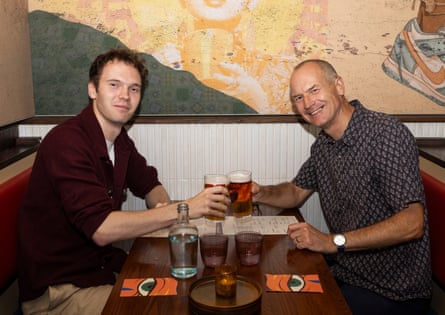 Oliver and Adrian clinking beer glasses