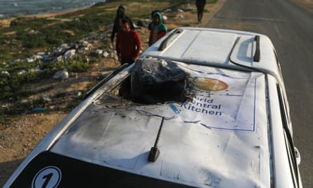 A vehicle with the logo of the World Central Kitchen with a hole torn in the roof by an Israeli airstrike