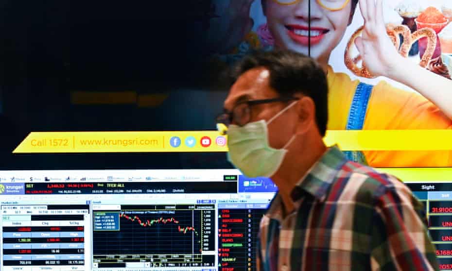 A man wearing a protective face mask in the Bangkok stock exchange in Thailand