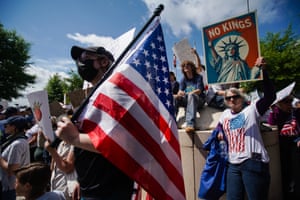people hold signs and flags