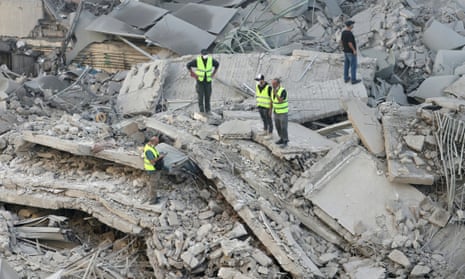 Rescuers check the site of an overnight Israeli airstrike in Beirut's southern suburb of Shayyah on 2 October.