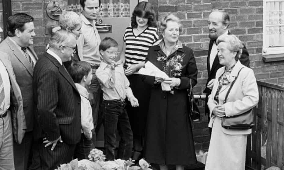 Margaret Thatcher hands a copy of the deeds to a house in Harold Hill, London, to the Patterson family, the Greater London Council’s 12,000th council house buyer, in 1980. 