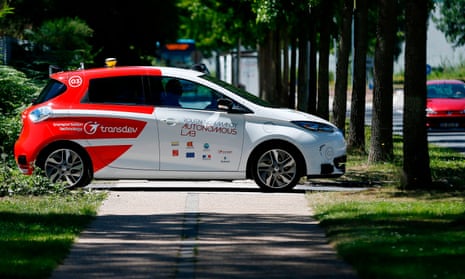 An autonomous car drives past on a street in France.