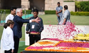 Malcolm Turnbull throws rose petals at the Raj Ghat in New Delhi, India, during his four-day visit.