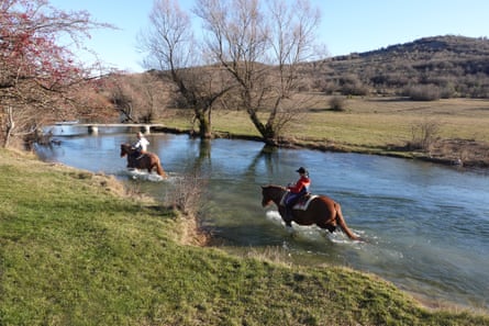 Riders splash down a river