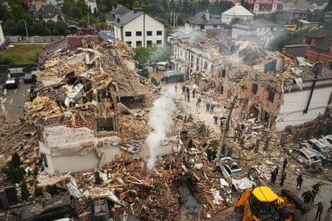 Rescuers work at the site of an apartment buildings damaged during a Russian attack in Kyiv.