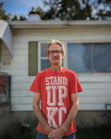 a man standing in front of a house