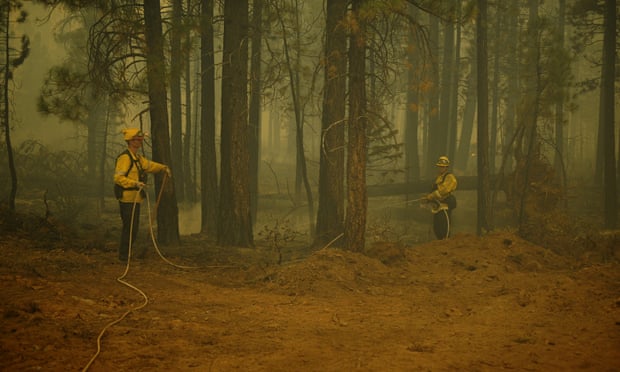 Firefighters battle the Dixie fire on Saturday in Crescent Mills, California.