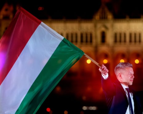 Peter Magyar, the leader of the opposition Tisza party, waves a national flag after a parliamentary election in Budapest, Hungary.