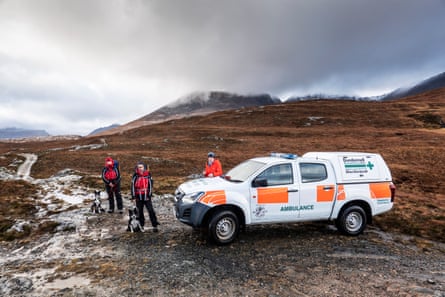 Alison Smith and her collie Meg, with Steve Worsley and his dog Rona, alongside the Dundonnell mountain rescue team ambulance.