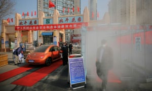 Disinfectant sprayed on people entering a residential compound in Tianjin, China
