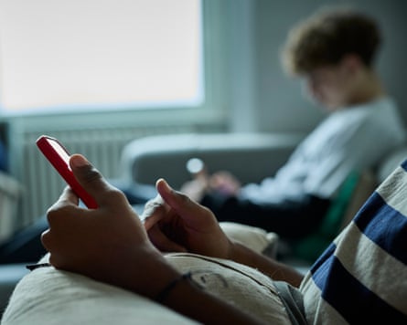 Teen boys on their mobile phones.