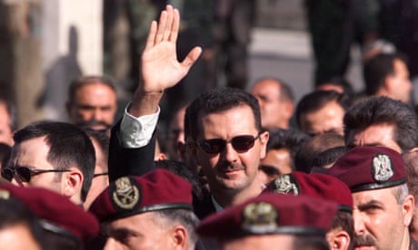Bashar al-Assad waves as he follows the funeral procession of his father Hafez al-Assad in Damascus in June 2000.