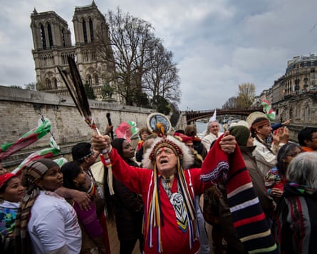 Indigenous representatives from around the world engage in a joint prayer session on board of a river boat on the Seine river, 6 December 2015.