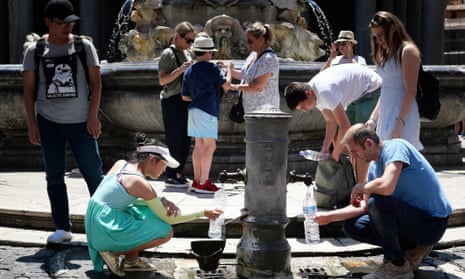 Tourists in Rome drink from a public fountain during the unusually early summer heatwave.