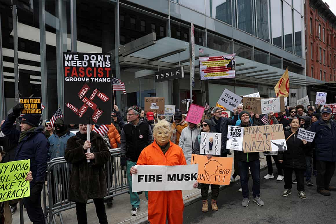 People protest outside a Tesla store