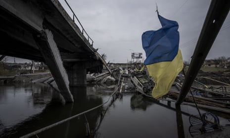 A Ukrainian flag flies at the destroyed bridge over the Irpin river, in Irpin 20 kilometres north-west of Kyiv. The bridge was blown up by Ukrainian forces to block - or at least slow - Russian forces reaching the capital.