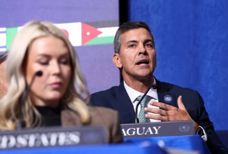 Peña speaks while seated behind the White House press secretary, Karoline Leavitt