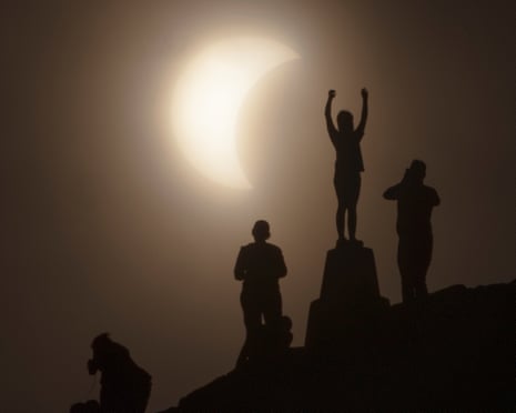 People gathered around the UK and Europe, including Arthur’s Seat in Edinburgh, to watch the solar eclipse on Wednesday.