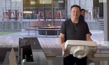 This image from the Twitter page of Elon Musk shows him entering Twitter headquarters carrying a sink.