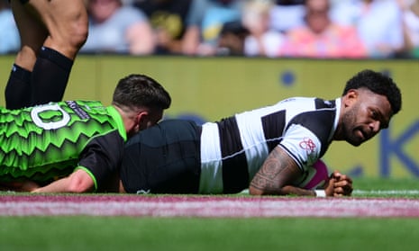 Seta Tamanivalu of Barbarians scores a try wearing the traditional black and white striped jersey.