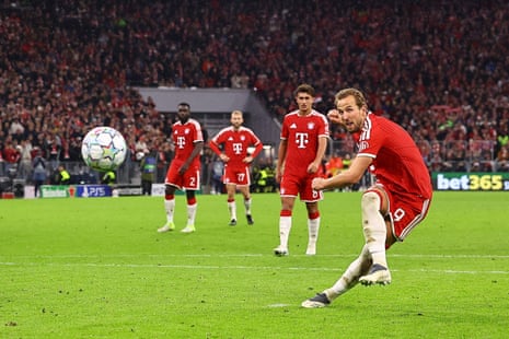 Harry Kane strikes a penalty kick for Bayern Munich as teammates watch behind