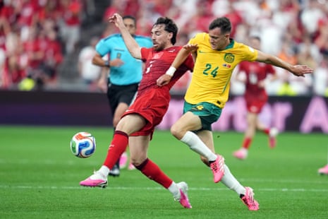 Turkey's Orkun Kokcu (6) challenges for the ball with Australia's Paul Okon-Engstler (24)