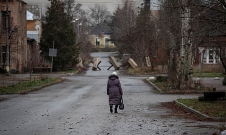 A woman walks on an empty street in Bakhmut, Ukraine, on 18 December.