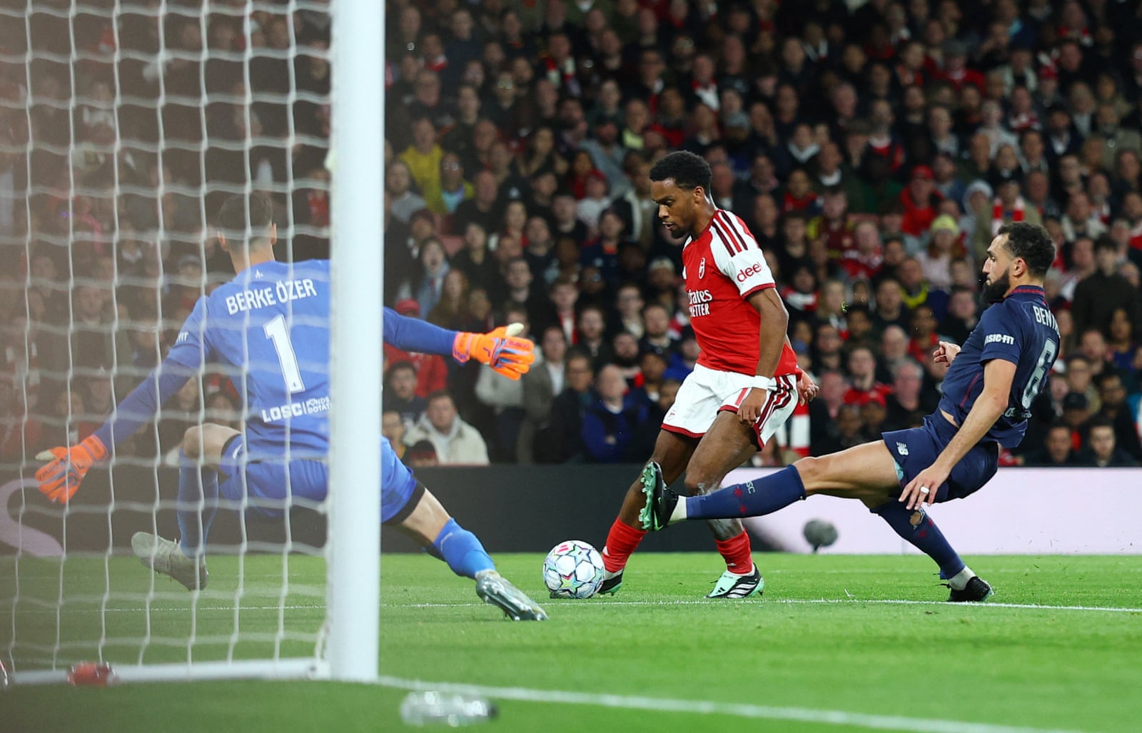 Jurriën Timber clips Arsenal's opening goal past Lille goalkeeper Berke Özer