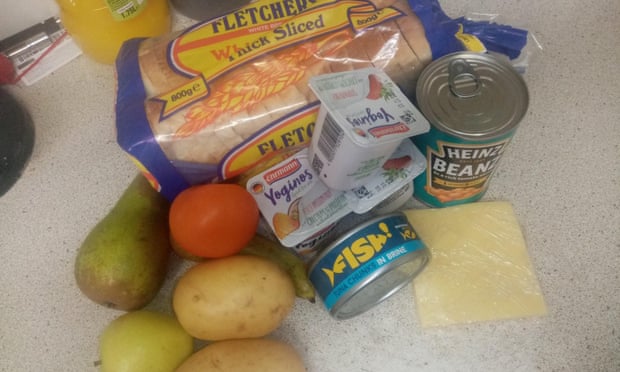 The food package received by a resident in Redcar, North Yorkshire, for her youngest child. Intended to last a week, it contained a loaf of bread, three yoghurts, a tin of beans, tuna, two potatoes, four pieces of fruit and two slices of cheese.