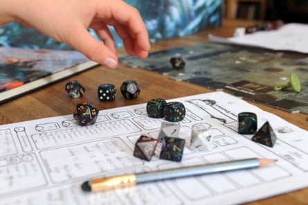 dice on table next to chart and pencil