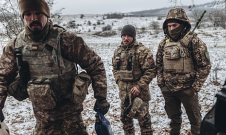 Ukrainian soldiers load firewood at their position on the Donbas frontline.