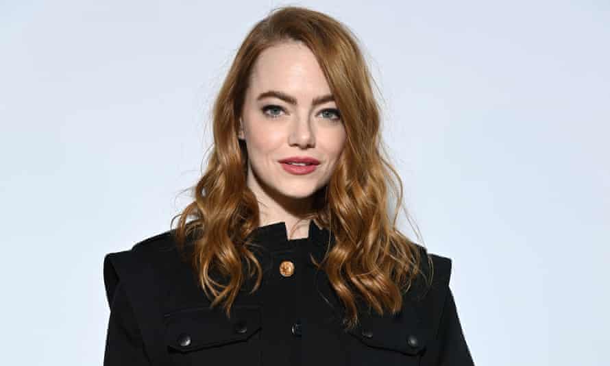 Emma Stone poses for a photo at the Louis Vuitton fashion show.