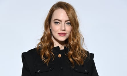 Emma Stone poses for a photo at the Louis Vuitton fashion show.
