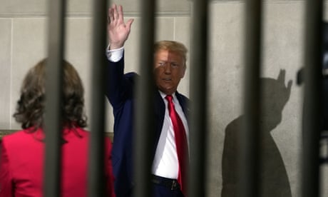 Donald Trump waving from behind a row of vertical bars. Donald Trump waving from behind a row of vertical bars.