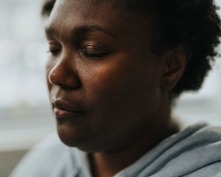 Women, eyes closed, looking sombre