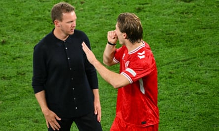 The Germany coach, Julian Nagelsmann, in discussion with Denmark’s Joachim Andersen.