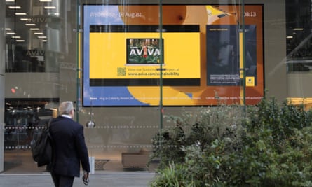 Pedestrian walks outside the Aviva head office in London