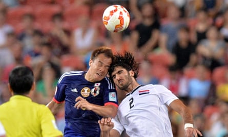 Shinji Okazaki of Japan and Ahmed Ibrahim of Iraq compete for the ball during the 2015 Asian Cup match between Iraq and Japan at Suncorp Stadium in Brisbane.
