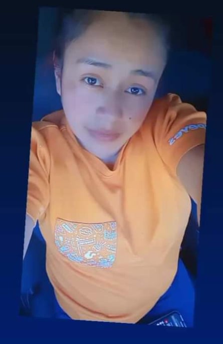A young woman takes a selfie.