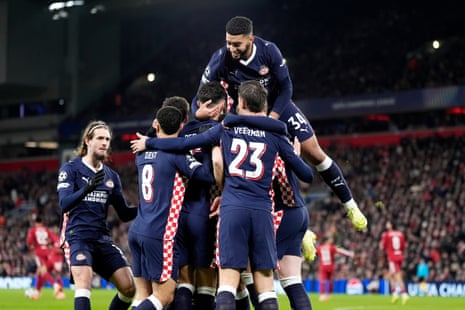 PSV Eindhoven's Ivan Perisic (hidden) celebrates with teammates after opening the scoring from the penalty spot at Liverpool.