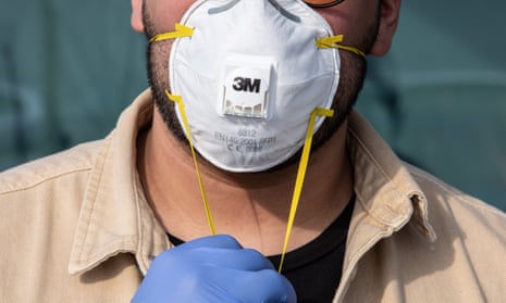 A man wearing a respiratory mask and gloves in south-west Milan.