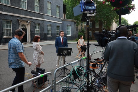 Journalists broadcasting from Downing Street.