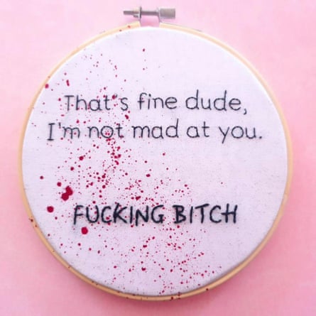 An embroidered circle that reads, “That’s fine dude, I’m not mad at you. FUCKING BITCH.” There is what appears to be blood splatter across the canvas.