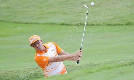 Rickie Fowler hits from the bunker on the third green