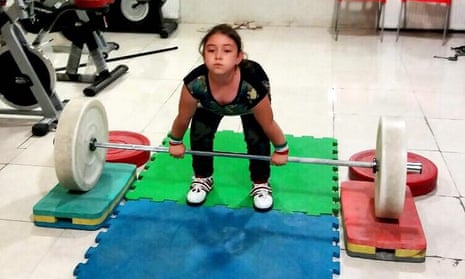 Aysan Adlib, aged eight, shows off her weightlifting skills.