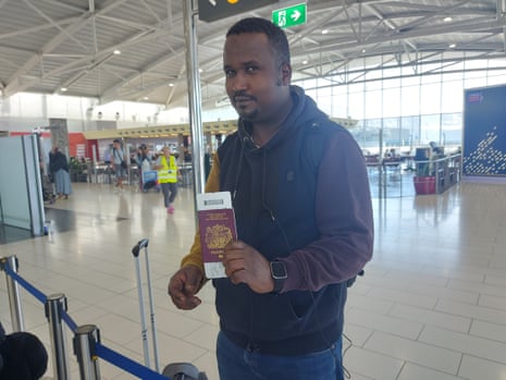 Sami Elhaj posing with his passport and boarding pass at Larnaca International Airport in Cyprus
