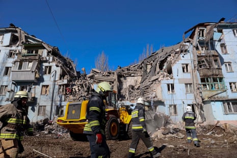 Rescuers at the five-storey residential building destroyed after a missile strike in Zaporizhzhia on 2 March.