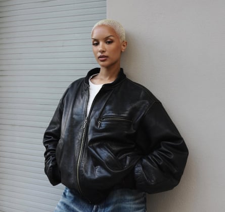 Imani Imani wearing a black leather jacket and blue jeans