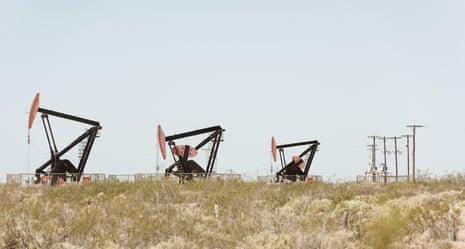 Three oil pump jacks at work in the Vaca Muerta field, Neuquen, Argentina.